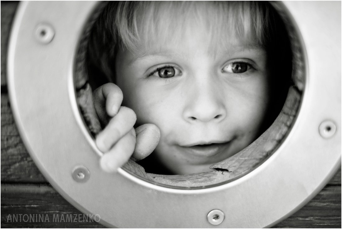 peeking from a pirate's ship at Diana's Memorial Playground in Kensignton, London