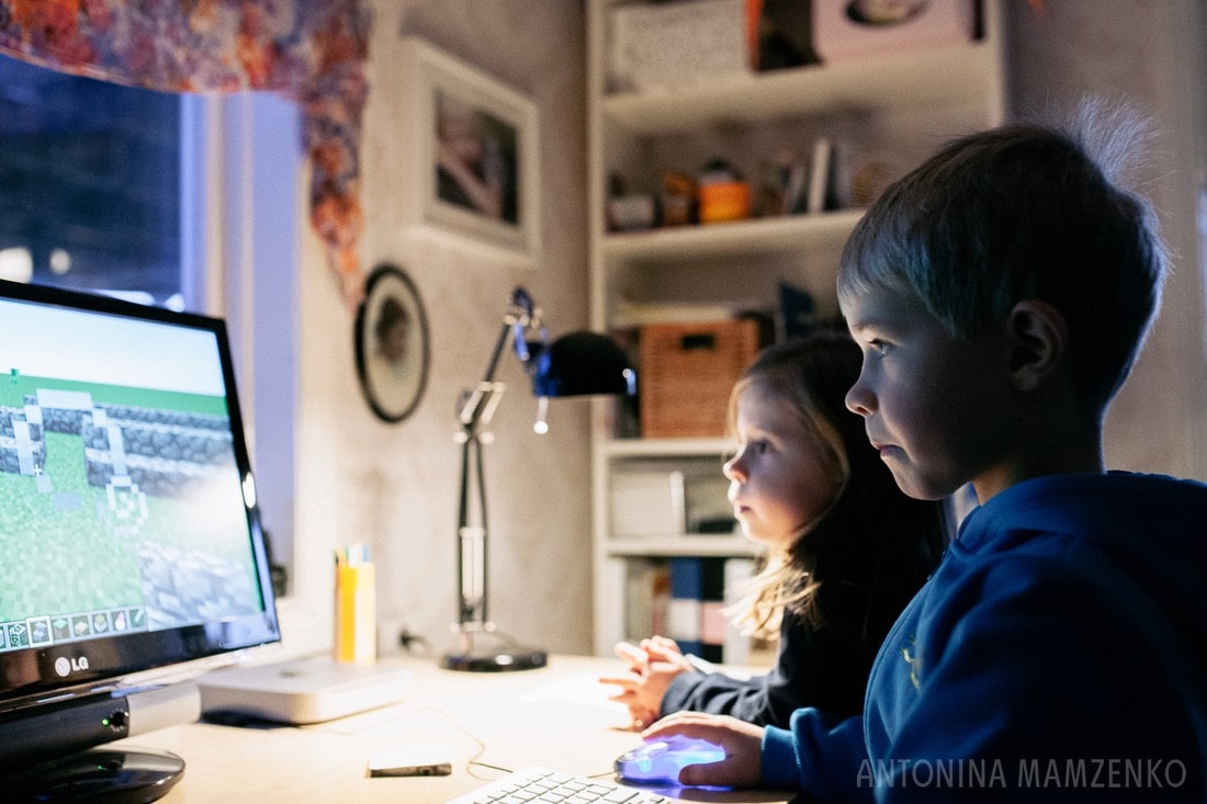 boy playing minecraft on pc at home