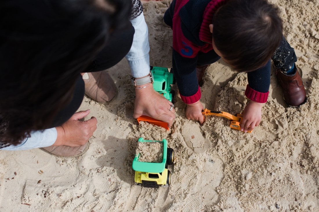 family playing at sandpit at bishop's park in fulham