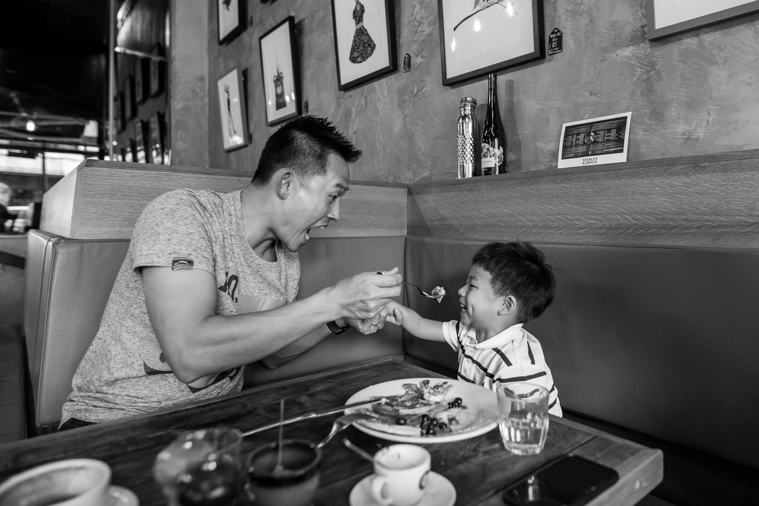 Father and son having breakfast in a London Kensington cafe